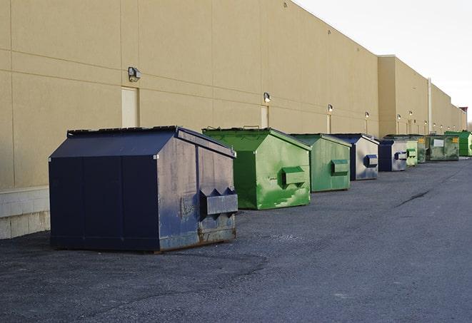 a yellow construction dumpster filled with waste materials in Felton, PA